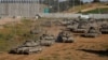 Israeli tanks maneuver on their way to Gaza near the Israel-Gaza border, in Israel, April 10, 2024.