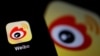 FILE - The logo of Chinese social media app Weibo is seen on a mobile phone in this picture taken Dec. 7, 2021. 