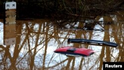 (FILE) A car is submerged in flood water after heavy rain from Storm Henk, Worcester, Britain.