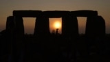 FILE - People gather at Stonehenge to celebrate the Summer Solstice, the longest day of the year, near Salisbury, England, June 21, 2023. (AP Photo/Kin Cheung)