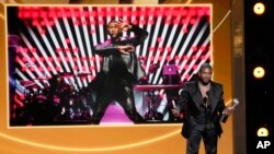 Usher speaks to the audience after winning Entertainer of the Year during the 55th NAACP Image Awards, March 16, 2024, at The Shrine Auditorium in Los Angeles. (AP Photo/Chris Pizzello)