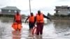 Kenyan Red Cross personnel and volunteers conduct search and rescue missions, around houses submerged by flood water in Machakos county, Kenya, April 22, 2024. 