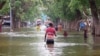 In this image made from video, residents move through floodwaters on a street in the town of Beledweyne, Somalia, Nov. 19, 2023. Officials say a cholera outbreak that started in Somalia in January is a consequence of the flooding in October and November.
