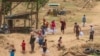 Internally displaced people from Myanmar take aid supplies from Thailand across the border in Mae Sot, Thailand, April 24, 2024. (Tommy Walker/VOA)