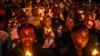 Young Rwandans hold flameless candles while taking part on a vigil during the commemorations of the 30th Anniversary of the 1994 Rwandan genocide at the BK Arena in Kigali, April 7, 2024. 