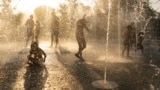 In this file photo, children play with water at a fountain during a heat wave, at Stavros Niarchos foundation Cultural Center in Athens, July 21, 2023. (AP Photo/Petros Giannakouris, File)