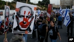 People take part in a protest against Israeli Prime Minister Benjamin Netanyahu's government, outside of the Knesset, Israel's parliament, in Jerusalem, March 31, 2024.