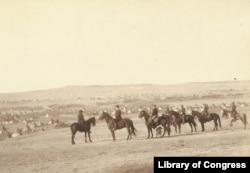 General Nelson A. Miles and staff view what National Archives records refer to as an "Indian Camp" near Pine Ridge, South Dakota, on Jan. 16, 1891, 18 days after the Wounded Knee massacre.