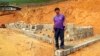 In this undated UGC photo released by the Cao family, the Rev. John Sanqiang Cao poses for photo near a construction site during his missionary work prior to 2017 in Northern Myanmar. (UGC photo/Cao Family via AP)