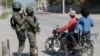 (FILE) Soldiers patrol the road near the international airport in Port-au-Prince, Haiti.