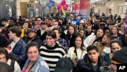 FILE - Commuters at Penn Station in New York City, Dec. 9, 2023, move to the platform to board a New Jersey Transit train. The U.S. government is changing, March 28, 2024, how it classifies people by race and ethnicity to count the population more accurately.
