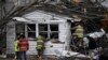 Members of the Huntsville Volunteer Fire Department enter a home to search for victims following a severe storm in Lakeview, Ohio, March 15, 2024. 