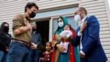 FILE - Canada's Prime Minister Justin Trudeau greets a family who recently resettled in Ottawa from Afghanistan, in Ottawa, Oct. 9, 2021. 