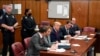 O antigo presidente Donald Trump na sala do tribunal de Nova Yorque, rodeado de advogados, quando foi formalmente inidiciado em Abril de 2023