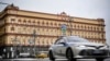 FILE - A police car goes past the headquarters of the Federal Security Service in central Moscow on March 3, 2023. Two Ukrainian journalists were detained by the Russian Federal Security Service in August 2023. Their whereabouts are unknown.