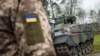 FILE - A Ukrainian soldier in front of a Marder infantry fighting vehicle in Munster, Germany, Feb. 20, 2023. Germany sends more in military aid to Ukraine.