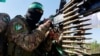 حماس کے مسلح دھڑے کا ایک جنگجو اس سال جولائی میں غزہ کی سرحد کے نزدیک ایک پریڈ میں۔ 