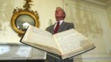 FILE - Archivist of the U.S John Carlin stands behind a 1947 Harry Truman presidential diary, July 10, 2003, at the National Archives in Washington. Presidents from George Washington to Joe Biden have kept presidential diaries. (AP Photo/Rick Bowmer, File)