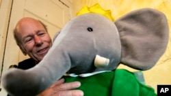 FILE - Babar author Laurent de Brunhoff poses for a photograph with Babar while celebrating 75 years of the book, April 21, 2006 at Mabel's Fables in Toronto.