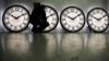 FILE - Peter Shugrue checks one of four custom clocks destined for installation in Kansas City, Missouri, at the Electric Time Company factory in Medfield, Massachusetts, March 8, 2013.