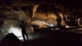 A person stands in Pebdeh Cave, in the Zagros Mountains, Iran, in this undated photo obtained by Reuters on March 25, 2024. Pebdeh Cave was occupied by hunter-gatherers as early as 42,000 years ago, inferred to be Homo Sapiens. (Mohammad Javad Shoaee/Handout via REUTERS)