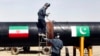 FILE - Iranian welders work on a pipeline to transfer natural gas from Iran to Pakistan, in Chabahar, near the Pakistani border, southeastern Iran, March 11, 2013.