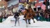 A skijoring team competes in Leadville, Colo., on Saturday, March 2, 2024. Skijoring draws its name from the Norwegian word skikjoring, meaning "ski driving." (AP Photo/Thomas Peipert)