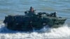 FILE - Filipino Marines maneuver their vehicle during an annual U.S.-Philippines joint military exercise on the beaches of Claveria, Cagayan province, Philippines, March 31, 2022. Maneuvers are planned off the west coast of the island of Palawan in April.