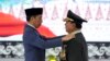 FILE - Indonesian Defense Minister Prabowo Subianto, right, receives four-star general epaulettes from President Joko Widodo during a ceremony at the Armed Forces Headquarters in Jakarta, Indonesia, Feb. 28, 2024.