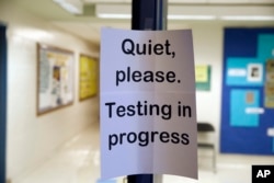 FILE - In this Jan. 17, 2016 file photo, a sign is seen at the entrance to a hall for a college test preparation class in Bethesda, Md.