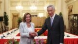 In this photo provided by Ministry of Communications and Information, Singapore, U.S. House Speaker Nancy Pelosi, left, and Prime Minister Lee Hsien Loong shake hands at the Istana Presidential Palace in Singapore, Monday, Aug. 1, 2022. (via AP)