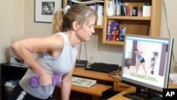 Woman exercises at home using an online class. (AP File Photo)
