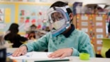 FILE - A student wears a mask and face shield in a 4th grade class amid the COVID-19 pandemic at Washington Elementary School on Jan. 12, 2022. (AP Photo/Marcio Jose Sanchez, File)