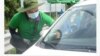 Một nhân viên dán thẻ trả phí đường bộ không dừng lên một xe ô tô ở Việt Nam. 