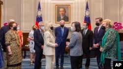 Taiwan's President Tsai Ing-wen chats with members of a delegation of U.S. Congress members during a meeting at the Presidential Office in Taipei, Taiwan, Aug. 15, 2022. (Taiwan Presidential Office via AP)
