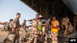 File - French soldiers of the boarding a transport airplane of the Interarmy Transit Detachment (DETIA), in Gao, amid the French military drawdown with troops leaving the last bases in Mali, June 28, 2022.