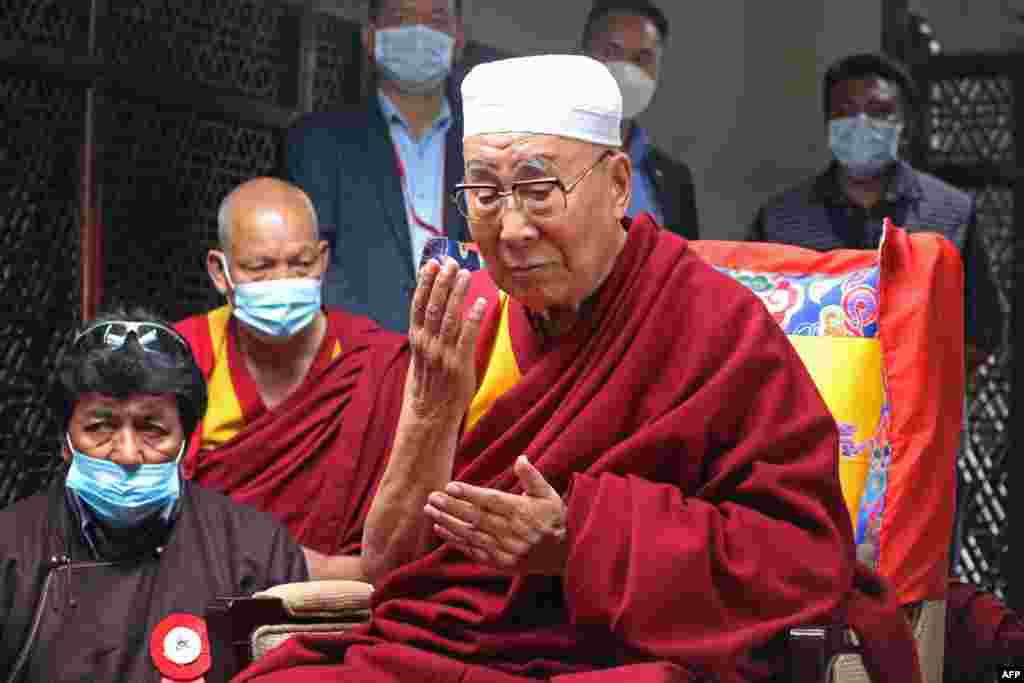 Tibetan spiritual leader Dalai Lama offers prayers during his visit at the Shah-e-Hamdan mosque at Shey village in Leh, India.