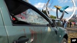FILE - Blood stains a car damaged in a deadly Russian missile attack in Vinnytsia, Ukraine, July 14, 2022. As Russia's war in Ukraine rages on, the Kremlin is expanding its information war throughout Eastern Europe, spreading propaganda and disinformation