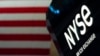 FILE - An NYSE sign is seen on the floor at the New York Stock Exchange in New York, June 15, 2022. 