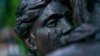 Raindrops fall down the face of a statue of a couple embracing in the city center, where many residents have evacuated from, in Druzhkivka, Donetsk region, eastern Ukraine, before a nightly curfew Aug. 18, 2022. 