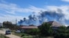 Фоторепортеры Reuters засняли клубы дыма на месте взрывов на аэродроме "Саки" у поселка Новофедоровка в Крыму, 9 августа 2022 г. 