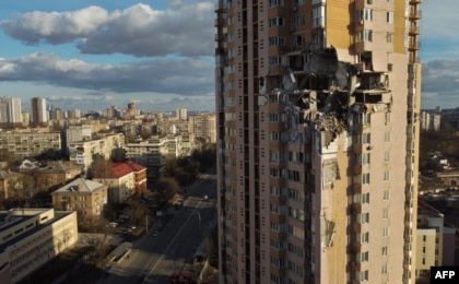 Damage to the upper floors of a building in Kyiv, Ukraine, after it was reportedly struck by a Russian rocket, Feb. 26, 2022.  