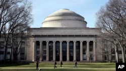 FILE - Students walk past the "Great Dome" atop Building 10 on the Massachusetts Institute of Technology campus, April 3, 2017, in Cambridge, Mass. (AP Photo/Charles Krupa, File)