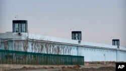 FILE - A person stands in a tower on the perimeter of the No. 3 Detention Center in Dabancheng in western China's Xinjiang Uyghur Autonomous Region on April 23, 2021. Human rights groups and Western nations have accused China of massive crimes against the Uyghur minority.