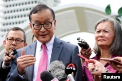 FILE: Self-exiled Cambodian opposition party founder Sam Rainsy and Mu Sochua, Deputy President of the Cambodia National Rescue Party (CNRP), speak to members of the media after leaving the Parliament House in Kuala Lumpur, Malaysia, November 12, 2019.