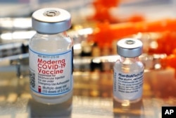 FILE - Vials for the Moderna and Pfizer COVID-19 vaccines are seen at a temporary clinic in Exeter, N.H. on Thursday, Feb. 25, 2021. The Food and Drug Administration has authorized another booster dose of the Pfizer or Moderna COVID-19 vaccine for people age 50 and up, Tuesday, March 29, 2022. (AP Photo/Charles Krupa, File)