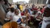 FILE - People queue to receive food donated by local residents at a reception center for the internally displaced, in Mekele, in Ethiopia's Tigray region, May 9, 2021.