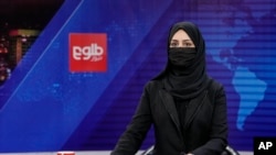 FILE - TV anchor Khatereh Ahmadi reads the news on TOLO NEWS, in Kabul, Afghanistan, May 22, 2022. The Taliban government suspended, April 16, 2024, the broadcast of two privately run local TV channels over alleged violations of official regulations and “Islamic values.”