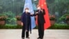 In this photo released by Xinhua News Agency, Chinese Foreign Minister Wang Yi, right, poses for photo with the United Nations High Commissioner for Human Rights Michelle Bachelet in Guangzhou, in southern China's Guangdong province, May 23, 2022.