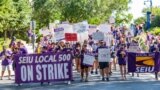 Workers march at American University as a way to pressure the school to work with their union on a contract. (Photo by Dylan Singleton)
